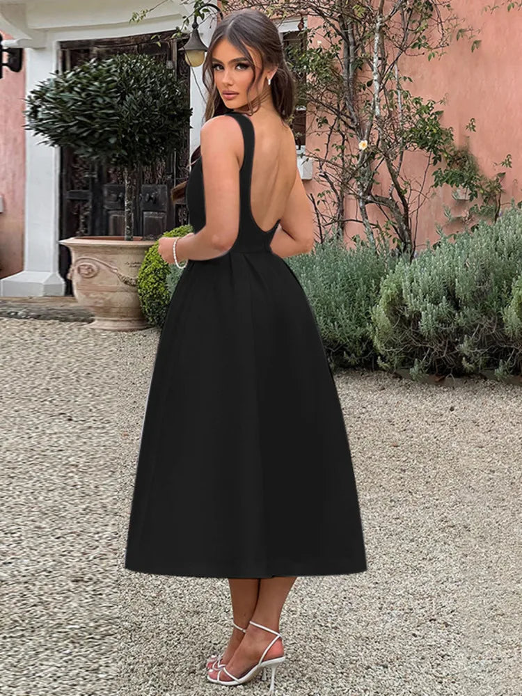 Woman wearing a light blue sleeveless Midi Dress with an A-line skirt, high boat neckline, V-shaped waist seam, low scoop back, and invisible zipper.