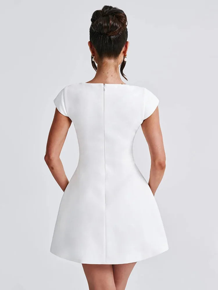 White mini dress with slight stretch, short regular sleeves, and a square collar neckline. A-line silhouette, above-knee length, with a zipper closure. Made from spandex and polyester.
