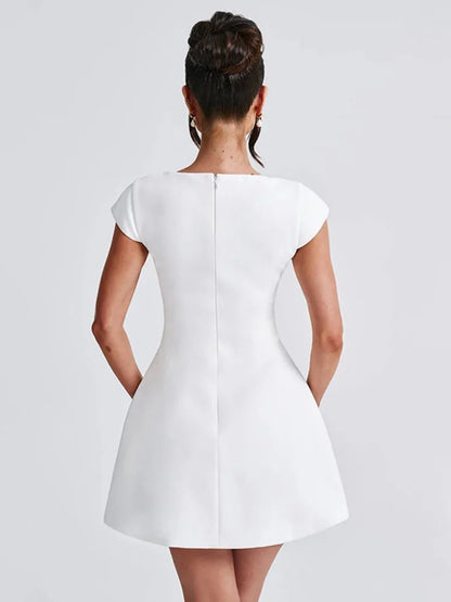 White mini dress with slight stretch, short regular sleeves, and a square collar neckline. A-line silhouette, above-knee length, with a zipper closure. Made from spandex and polyester.