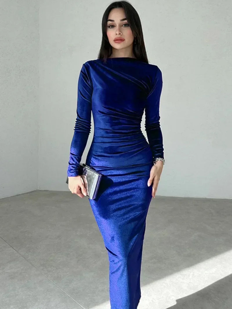 Woman wearing a blue Midi Dress in velvet, featuring an O-neckline, long sleeves, high waist, and folded detailing with a mid-calf length 
