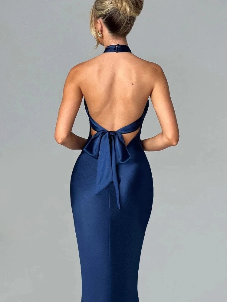 Woman wearing a blue Elegant backless satin dress with a neck-mounted halter design, lace-up detail, and slim fit silhouette