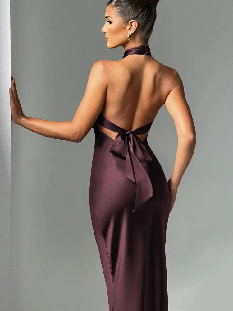 Woman wearing a brown Elegant backless satin dress with a neck-mounted halter design, lace-up detail, and slim fit silhouette