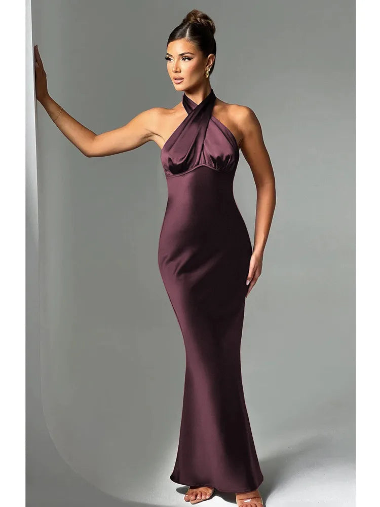 Woman wearing a brown Elegant backless satin dress with a neck-mounted halter design, lace-up detail, and slim fit silhouette