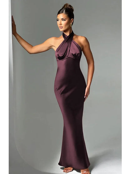Woman wearing a brown Elegant backless satin dress with a neck-mounted halter design, lace-up detail, and slim fit silhouette