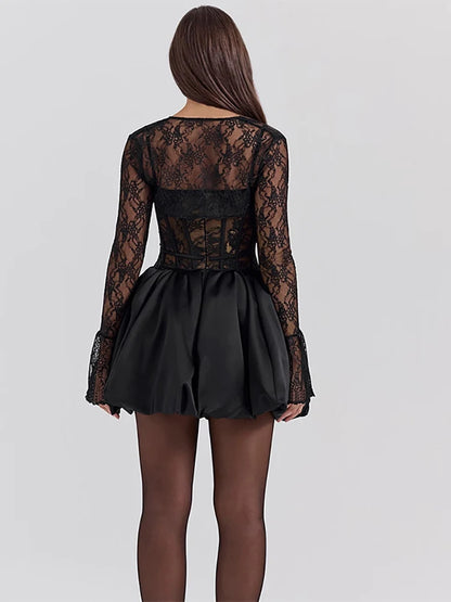 Woman wearing a blacl two-piece Mini Dress with a sheer lace long-sleeve top and a sleeveless spaghetti strap mini dress with a lace-print corset bodice and A-line satin skirt