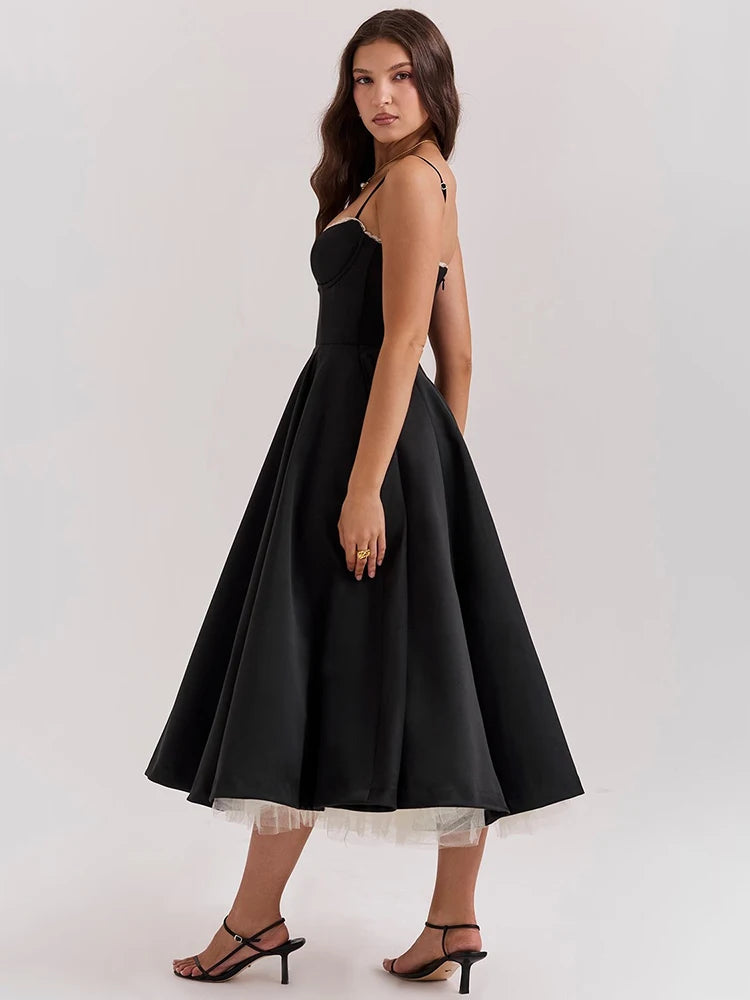 Black A-line dress with slight stretch, mid-calf length, and spaghetti straps. Features a strapless neckline and zipper closure.
