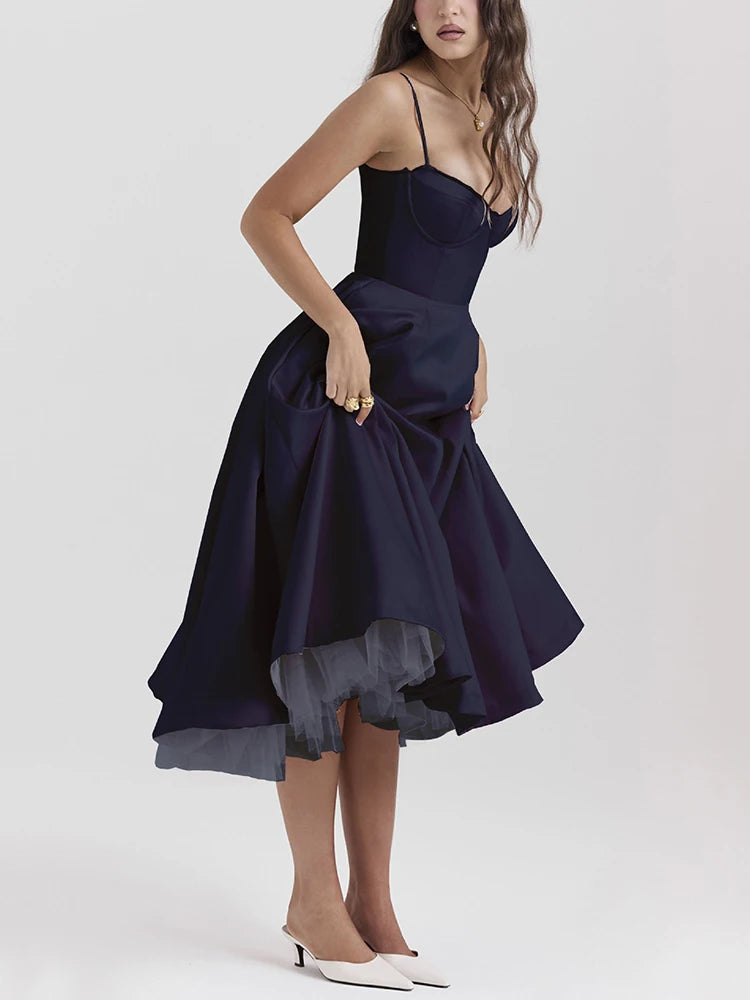 Dark blue A-line dress with slight stretch, mid-calf length, and spaghetti straps. Features a strapless neckline and zipper closure.