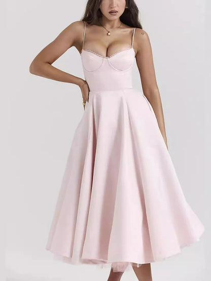 Light pink A-line dress with slight stretch, mid-calf length, and spaghetti straps. Features a strapless neckline and zipper closure.