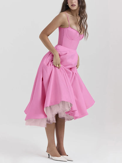Pink A-line dress with slight stretch, mid-calf length, and spaghetti straps. Features a strapless neckline and zipper closure.