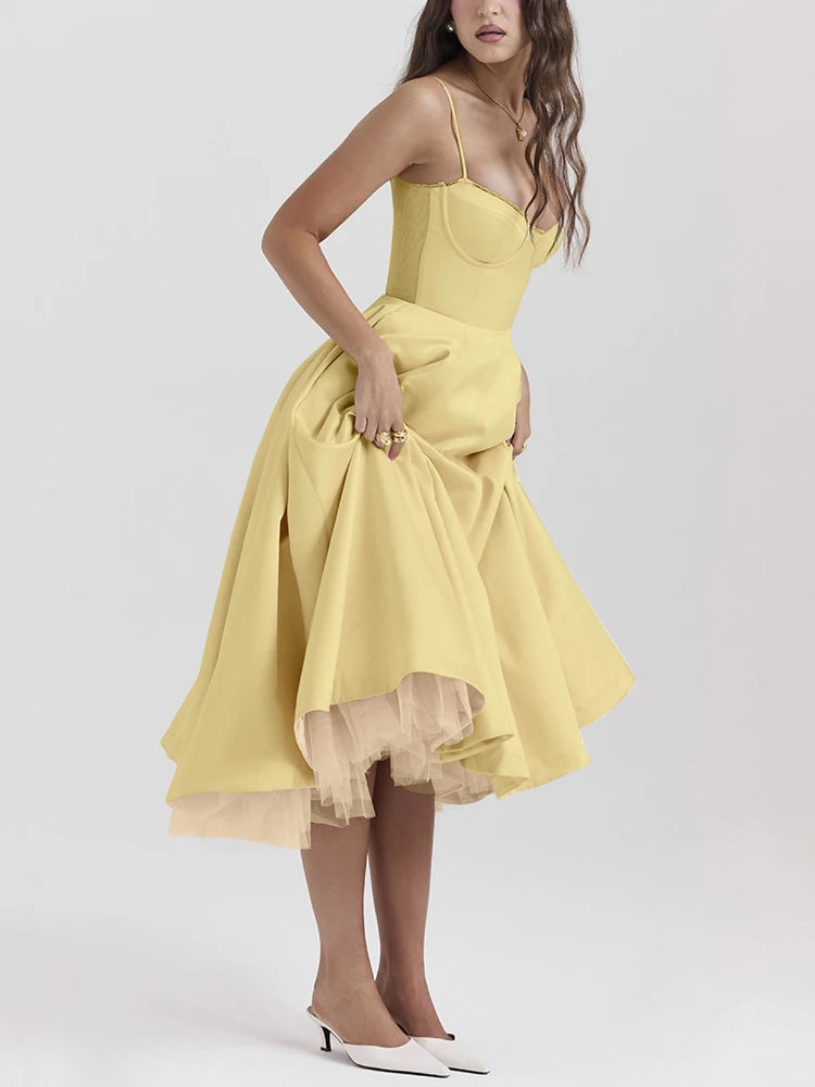 Yellow A-line dress with slight stretch, mid-calf length, and spaghetti straps. Features a strapless neckline and zipper closure.